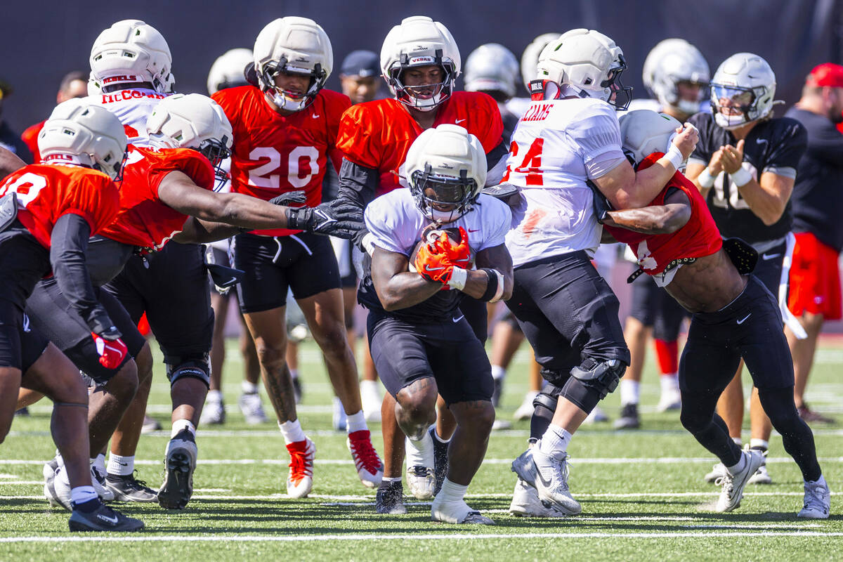UNLV running back Jaylon Glover (20) breaks free from the line on a run during football practic ...