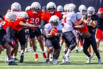 UNLV running back Jaylon Glover (20) breaks free from the line on a run during football practic ...