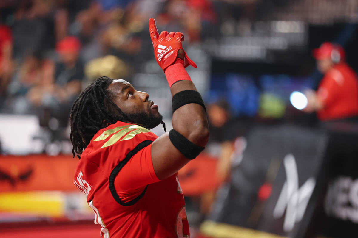 Knight Hawks defensive back Darius Williams (21) points to the sky after praying in the end zon ...