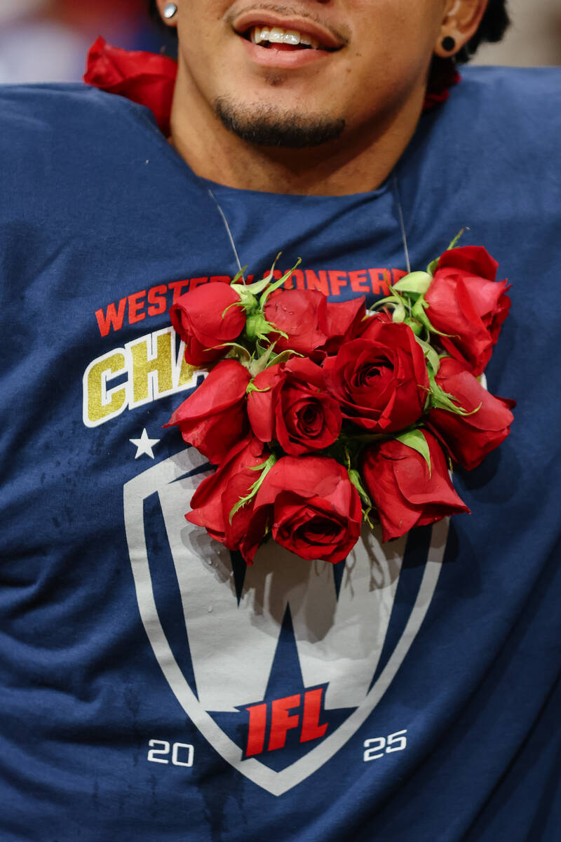 Roses fill Knight Hawks quarterback Jayden De Laura’s T-shirt and jersey after the Knigh ...