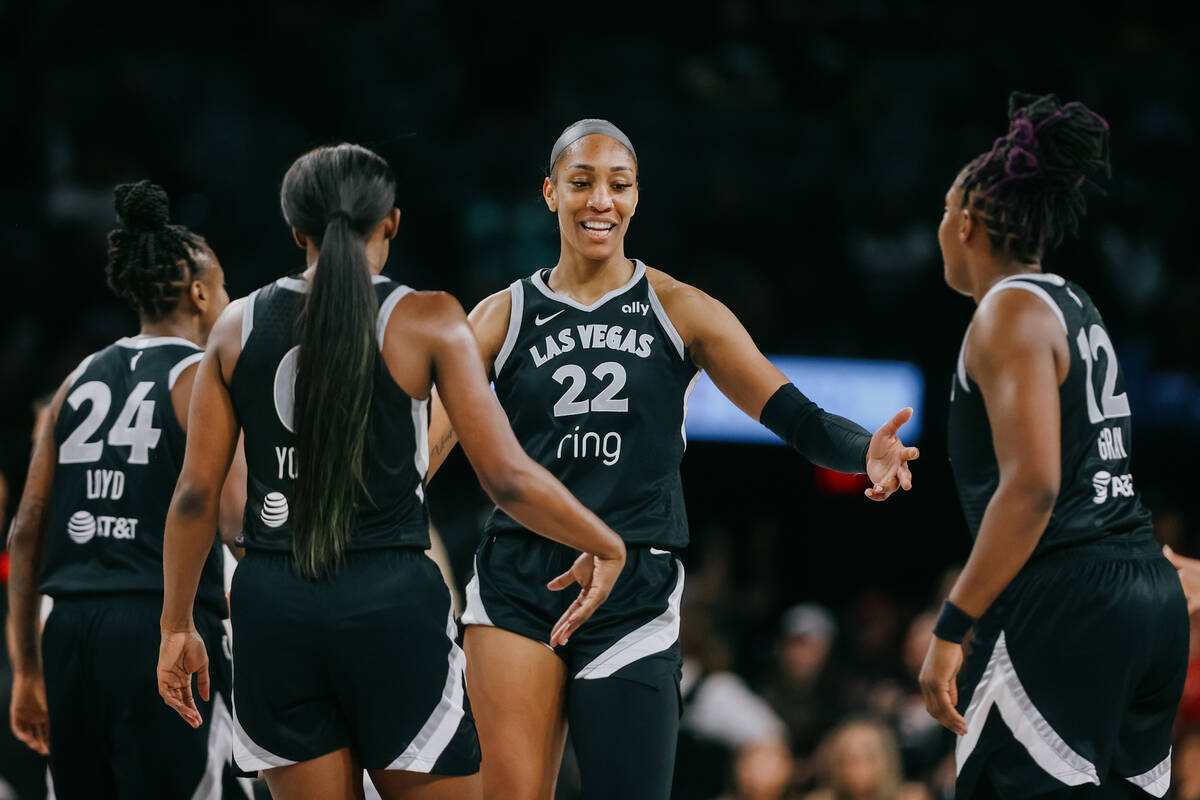 Aces center A'ja Wilson (22) celebrates with her teammates during a WNBA game between the Aces ...