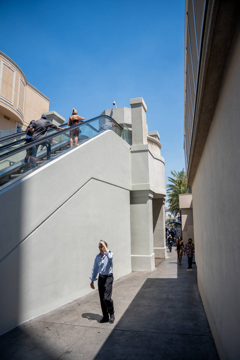 Pedestrians pass by the elevator towers along The Strip on Aug. 5, 2025 in Las Vegas. The Clark ...
