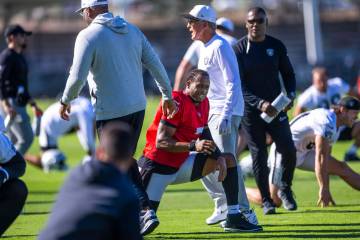 Raiders quarterback Geno Smith (7) speaks as head coach Pete Carroll walks past as his players ...