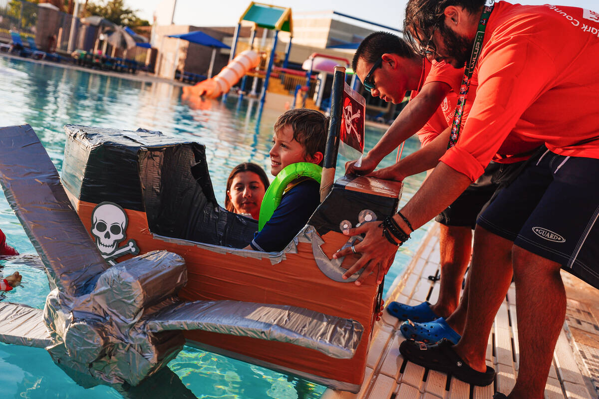 RJ Duensing, 9, gets into his boat during a boat regatta competition at Desert Breeze Swimming ...