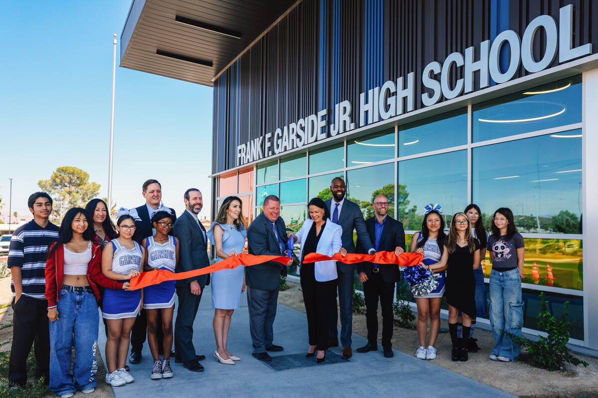 A ribbon is cut during the Frank F. Garside Junior High School ribbon cutting ceremony at Frank ...