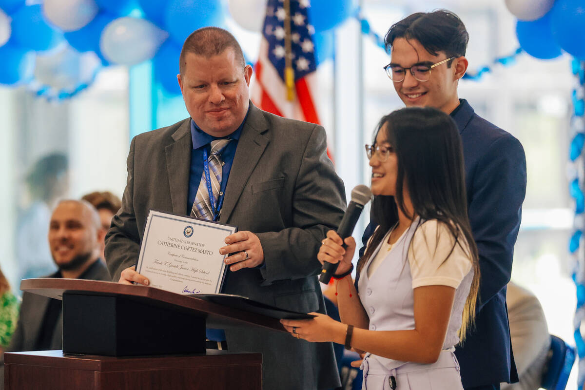 Frank F. Garside Junior High School Principal Matthew Spurk holds up a certificate during the F ...
