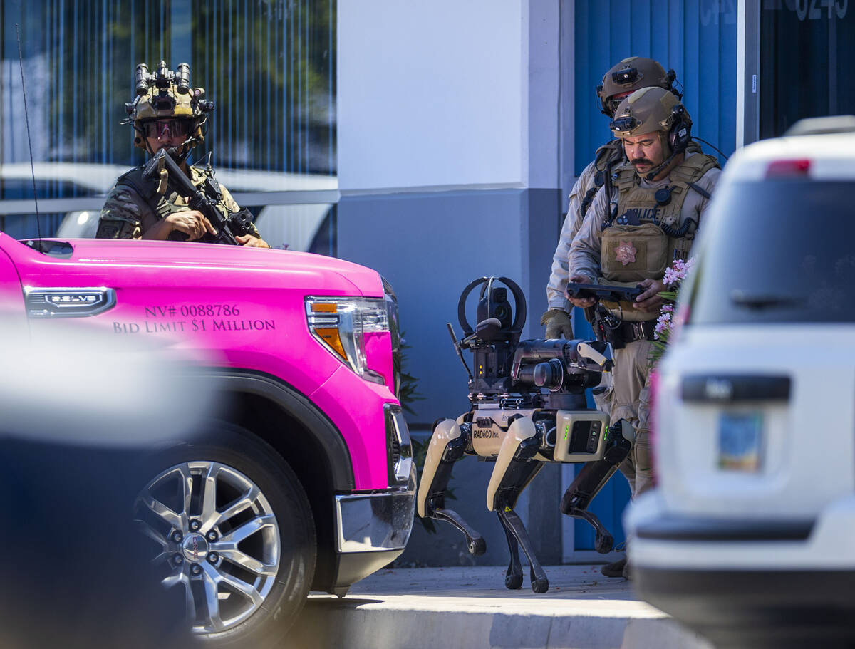 Tactical Operations officers with North Las Vegas Police use a robot dog assisting with their P ...