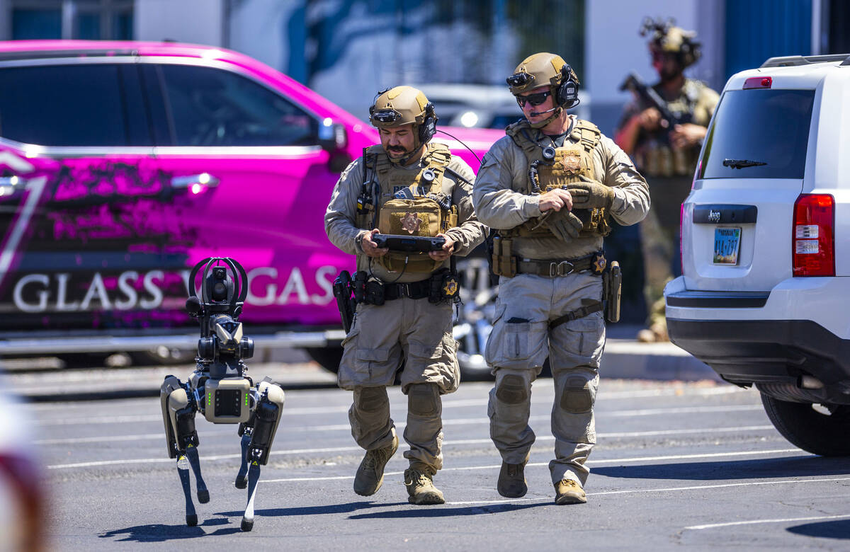 Tactical Operations officers with North Las Vegas Police use a robot dog assisting with their P ...