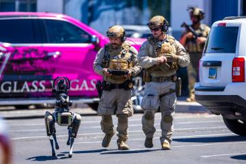 Tactical Operations officers with North Las Vegas Police use a robot dog assisting with their P ...