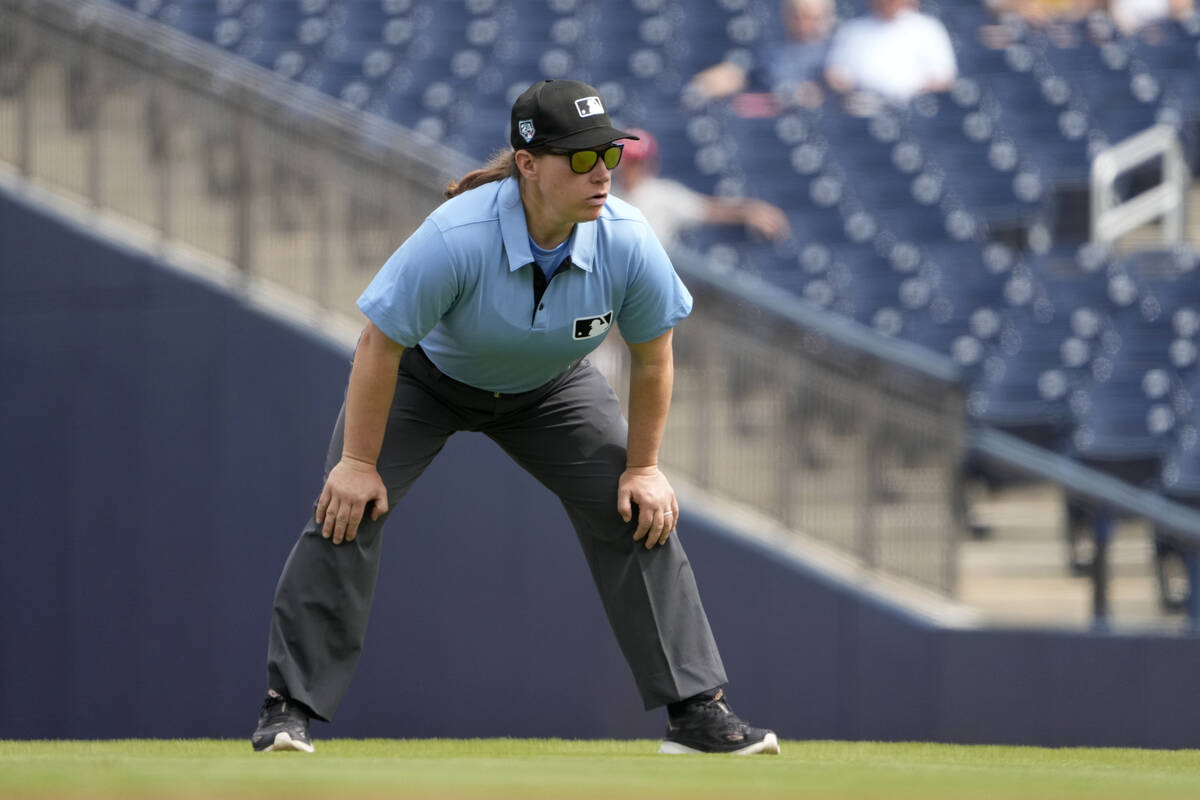 Umpire Jen Pawol takes her position during the first inning of a spring training baseball game ...