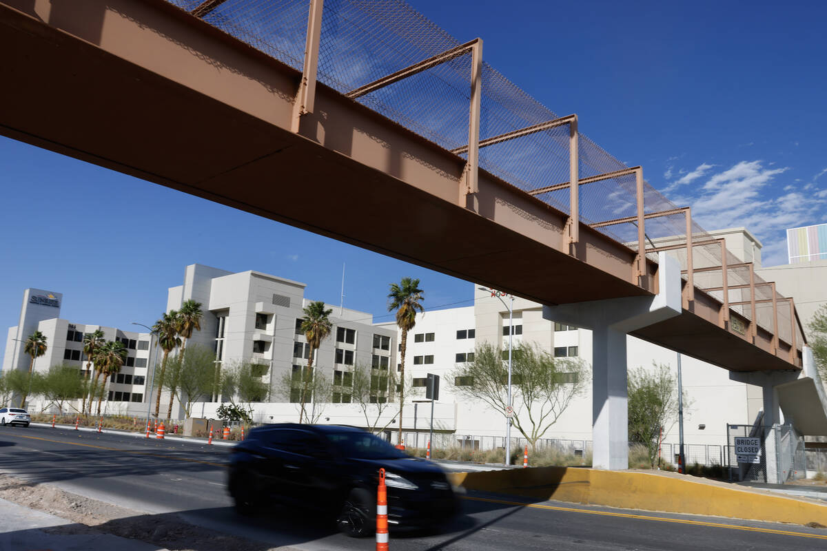 A motorist drives under the pedestrian bridge adjacent to Sunrise Hospital and Medical Center o ...