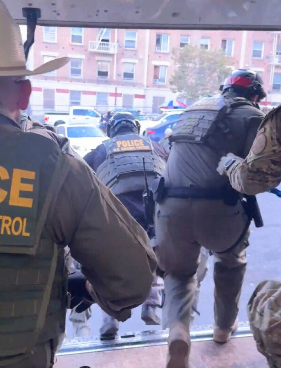 This image shows U.S. Border Patrol agents jumping out of a Penske box truck during an immigrat ...