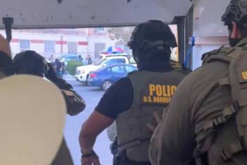 This image shows U.S. Border Patrol agents jumping out of a Penske box truck during an immigrat ...