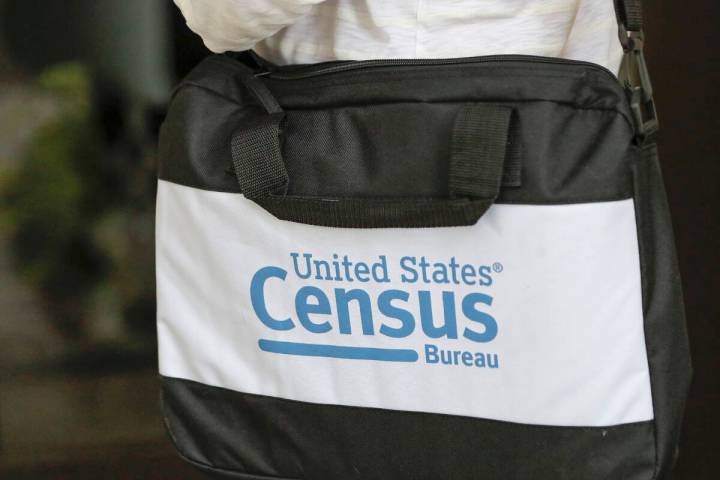 FILE - A briefcase of a census taker is seen as she knocks on the door of a residence, Aug. 11, ...
