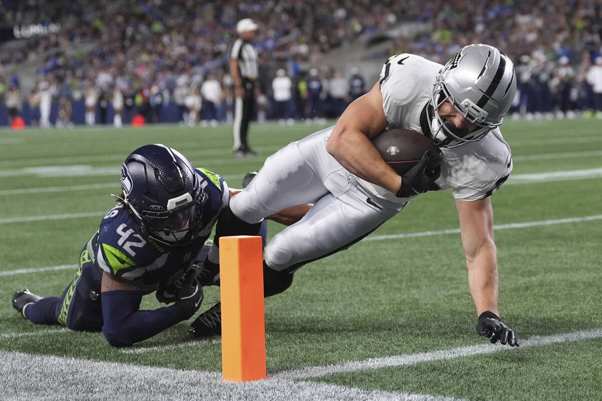 Las Vegas Raiders running back Dylan Laube (23) scores a touchdown past Seattle Seahawks lineba ...