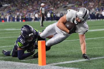 Las Vegas Raiders running back Dylan Laube (23) scores a touchdown past Seattle Seahawks lineba ...