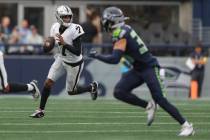 Las Vegas Raiders quarterback Geno Smith (7) looks to throw the ball during the first half of a ...