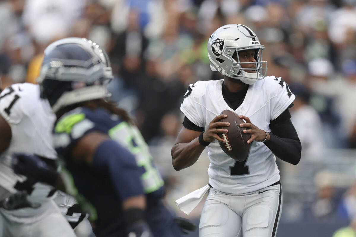 Las Vegas Raiders quarterback Geno Smith (7) looks to throw the ball during the first half of a ...