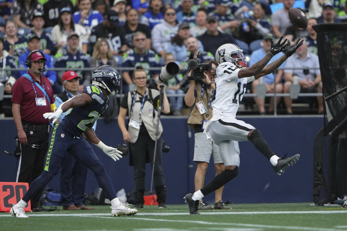 Las Vegas Raiders wide receiver Dont'e Thornton Jr. (10) tries to grab the ball as Seattle Seah ...
