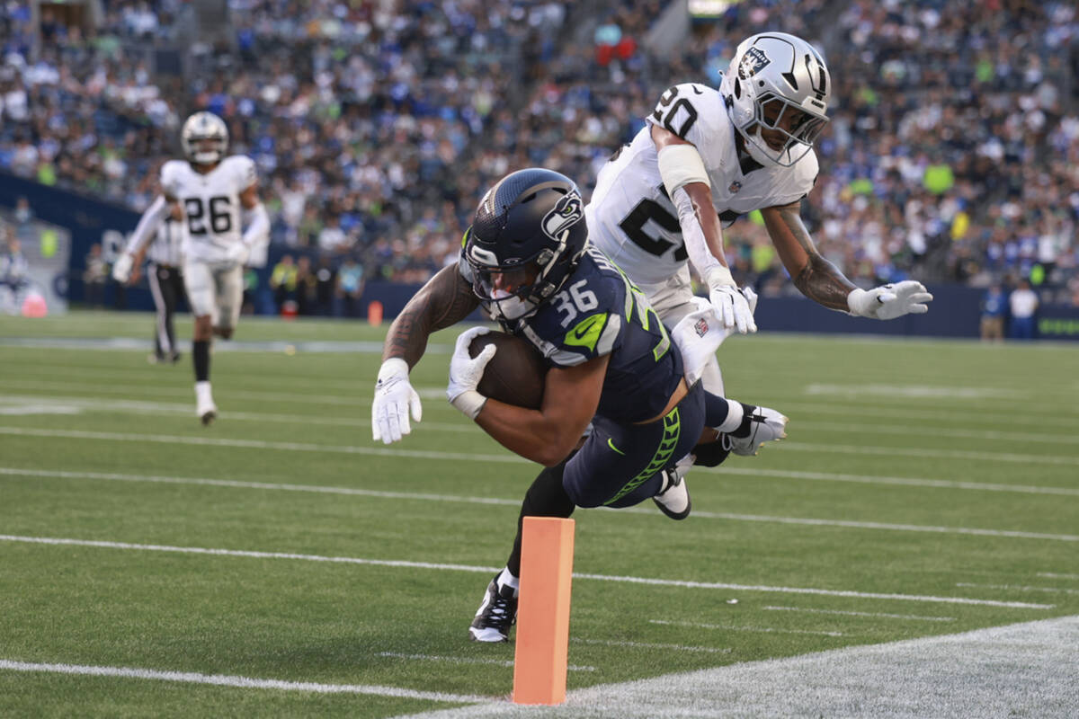 Seattle Seahawks running back George Holani (36) scores a touchdown past Las Vegas Raiders safe ...
