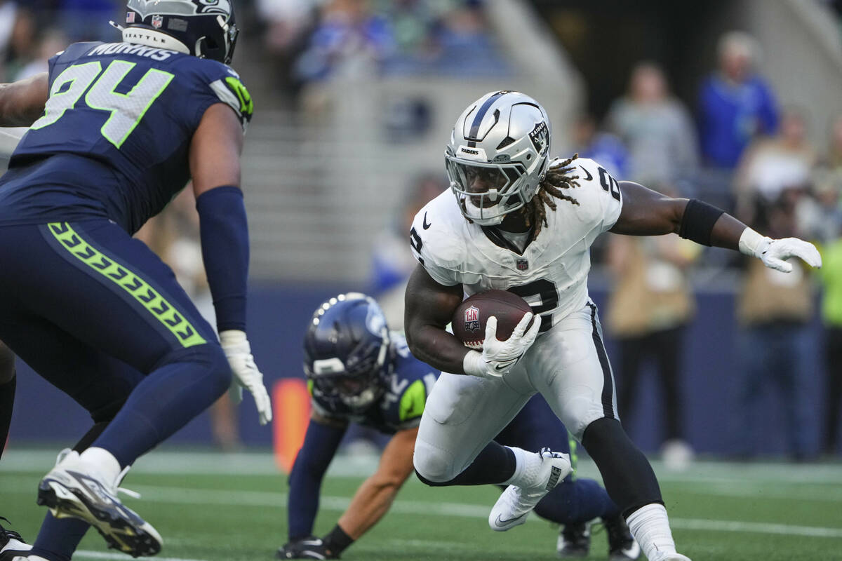 Las Vegas Raiders running back Ashton Jeanty (2) looks to get around Seattle Seahawks defense d ...