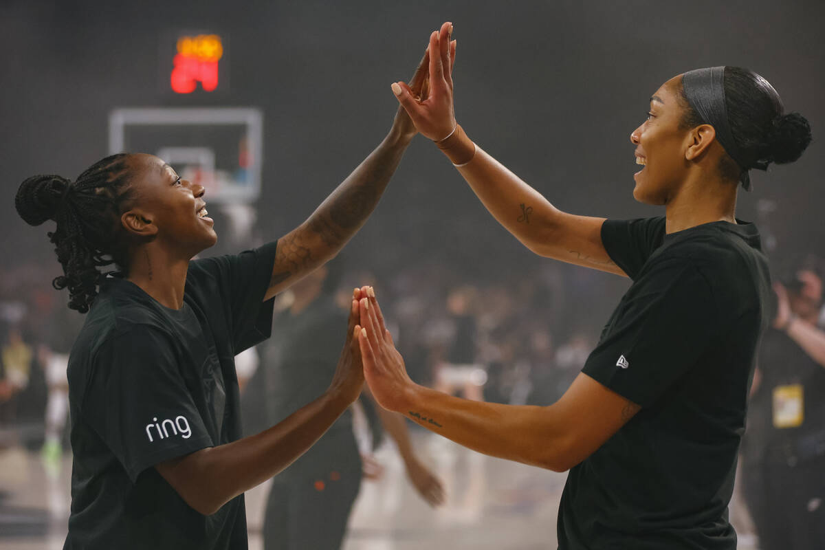 Las Vegas Aces guard Jewell Loyd (24) and Las Vegas Aces center A'ja Wilson (22) do a handshake ...