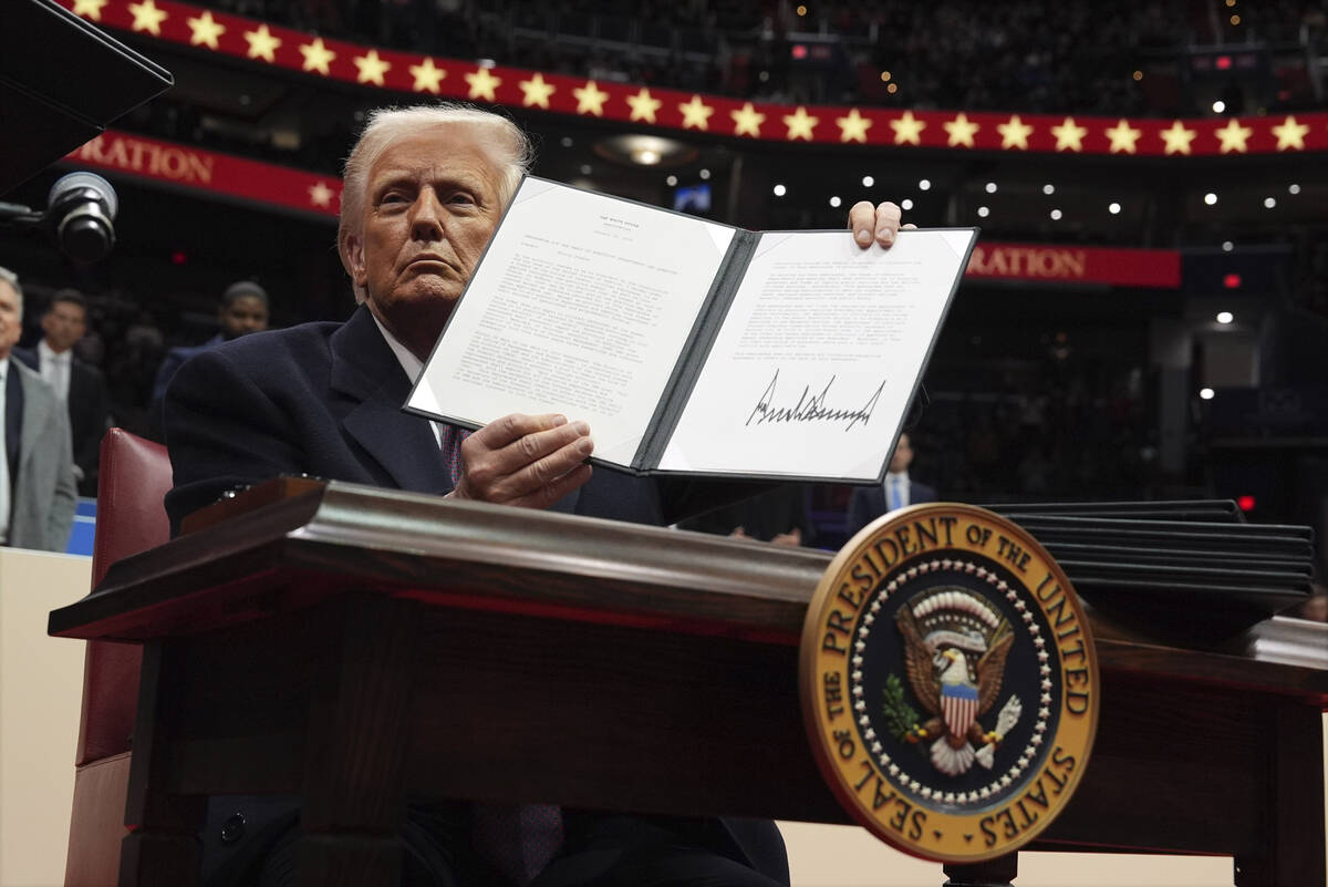 President Donald Trump signs an executive order. (AP Photo/Evan Vucci)