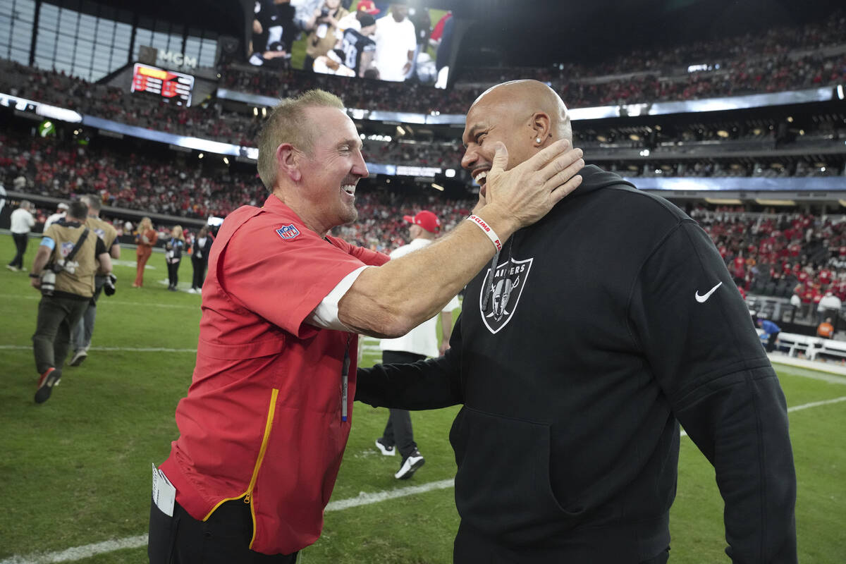 Kansas City Chiefs defensive coordinator Steve Spagnuolo, left, laughs with Las Vegas Raiders h ...