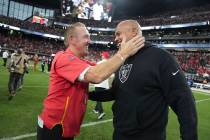 Kansas City Chiefs defensive coordinator Steve Spagnuolo, left, laughs with Las Vegas Raiders h ...