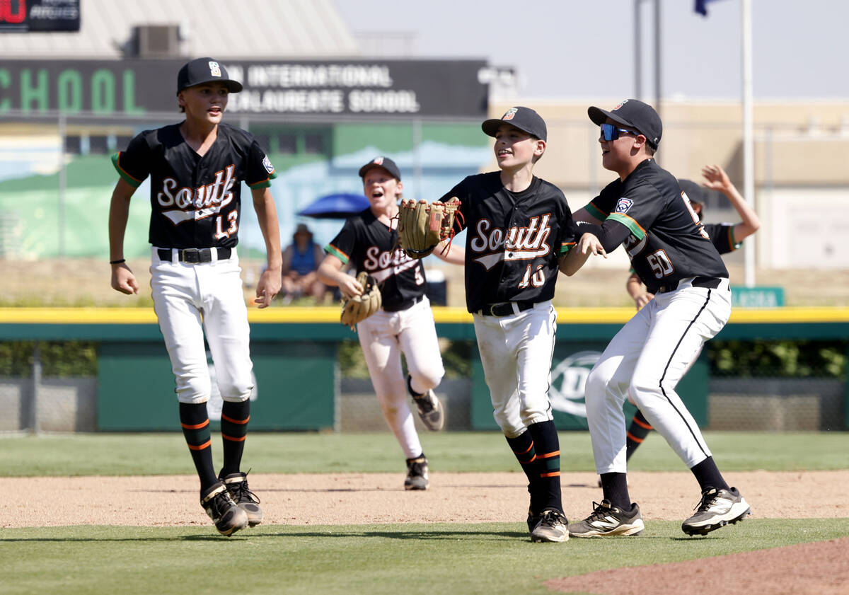 Nevada players celebrate their 6-3 win against Utah during the Mountain Regional final baseball ...