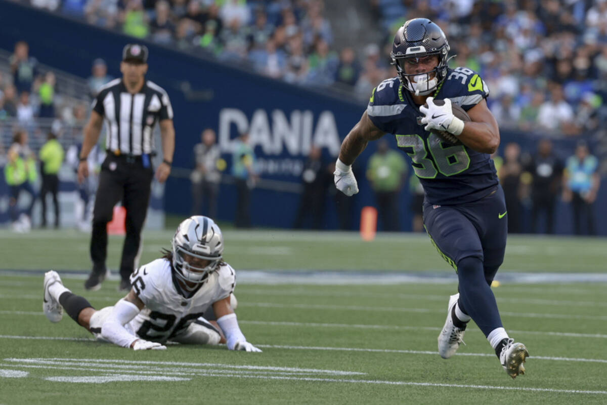 Seattle Seahawks running back George Holani (36) runs for a touchdown as Las Vegas Raiders corn ...