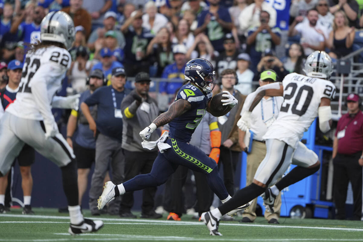 Seattle Seahawks running back George Holani (36) runs for a touchdown during the first half of ...
