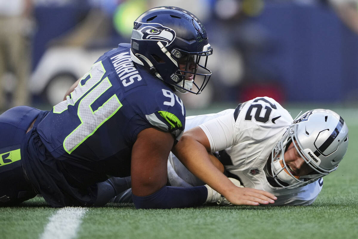 Seattle Seahawks defensive end Mike Morris (94) forces an incomplete against Las Vegas Raiders ...