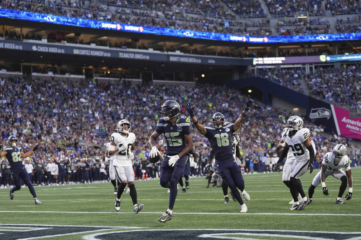 Seattle Seahawks wide receiver Tory Horton (15) scores a touchdown during the first half of an ...