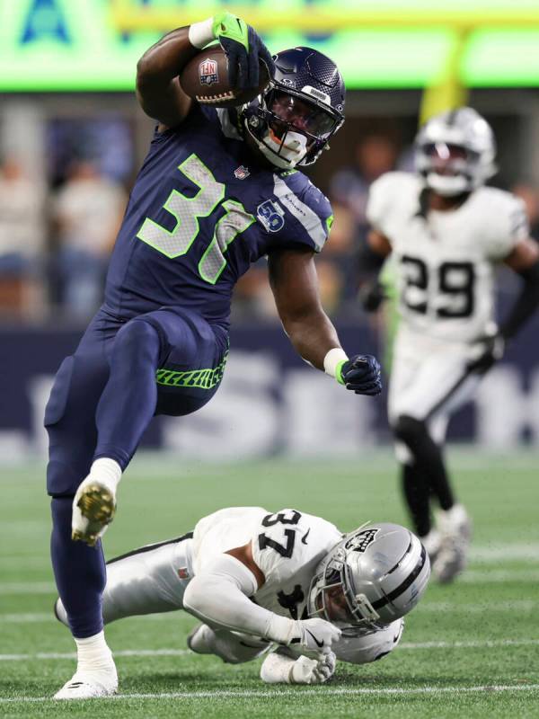 Seattle Seahawks running back Jacardia Wright (31) runs past Las Vegas Raiders safety Trey Tayl ...