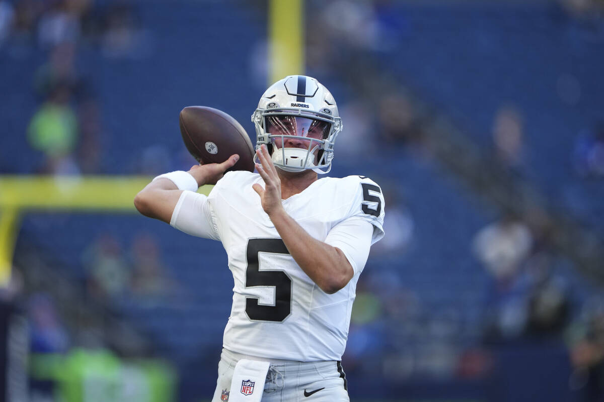 Las Vegas Raiders quarterback Cam Miller (5) warms up before an NFL preseason football game aga ...
