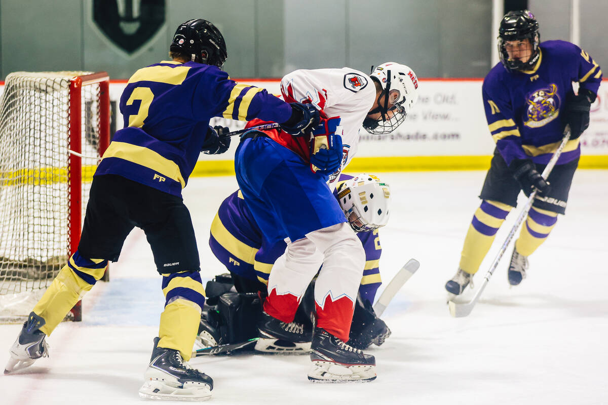 A goalie makes a save during a Golden Knights high school hockey league game at America First C ...