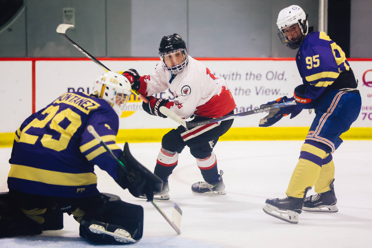 A player eyes an opponent during a Golden Knights high school hockey league game at America Fir ...