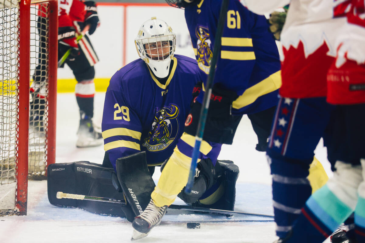 A goalie makes a save during a Golden Knights high school hockey league game at America First C ...