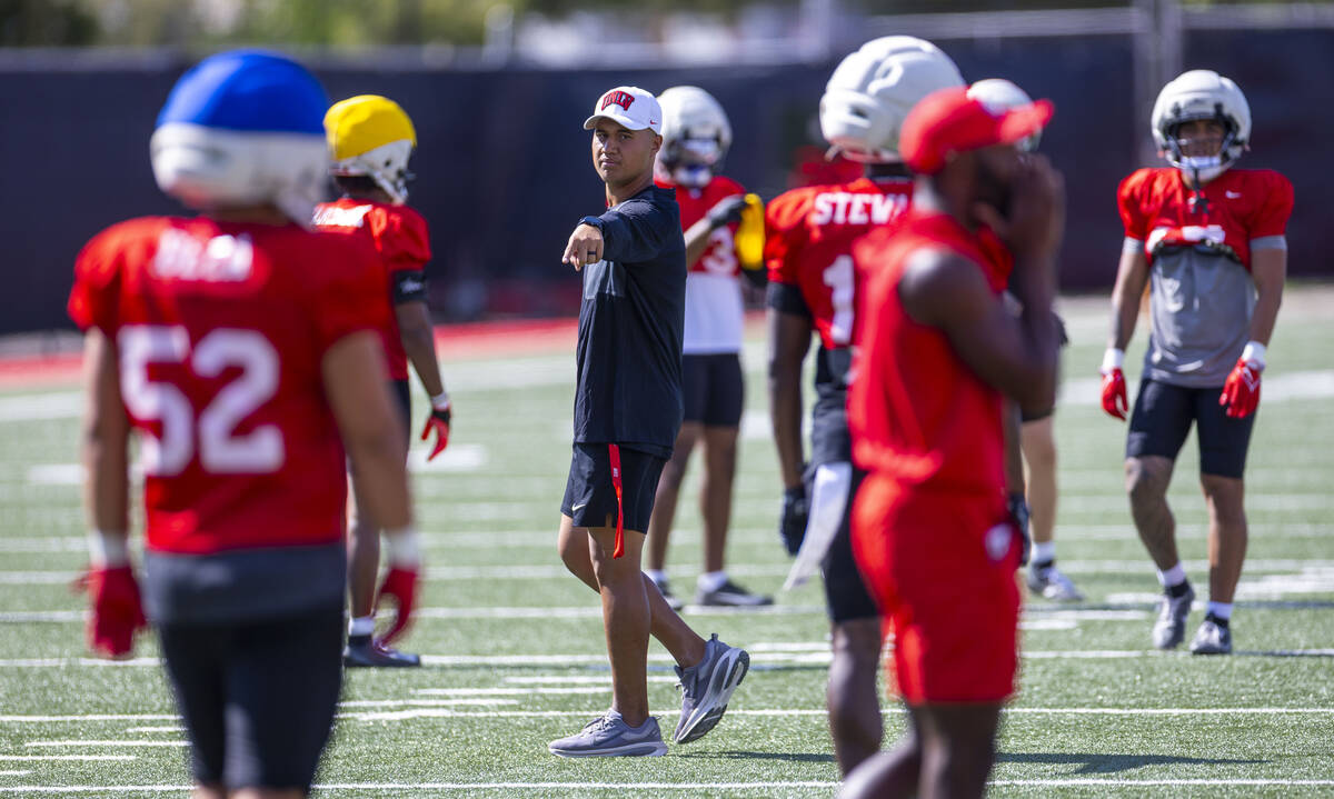 UNLV linebacker's coach Bam Amina directs a player during football practice at Fertitta Field o ...