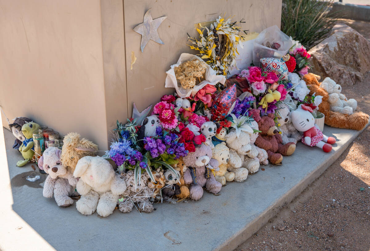 Stuffed animals rest along the roadside outside Arbor View High School in Las Vegas Aug. 8, 202 ...