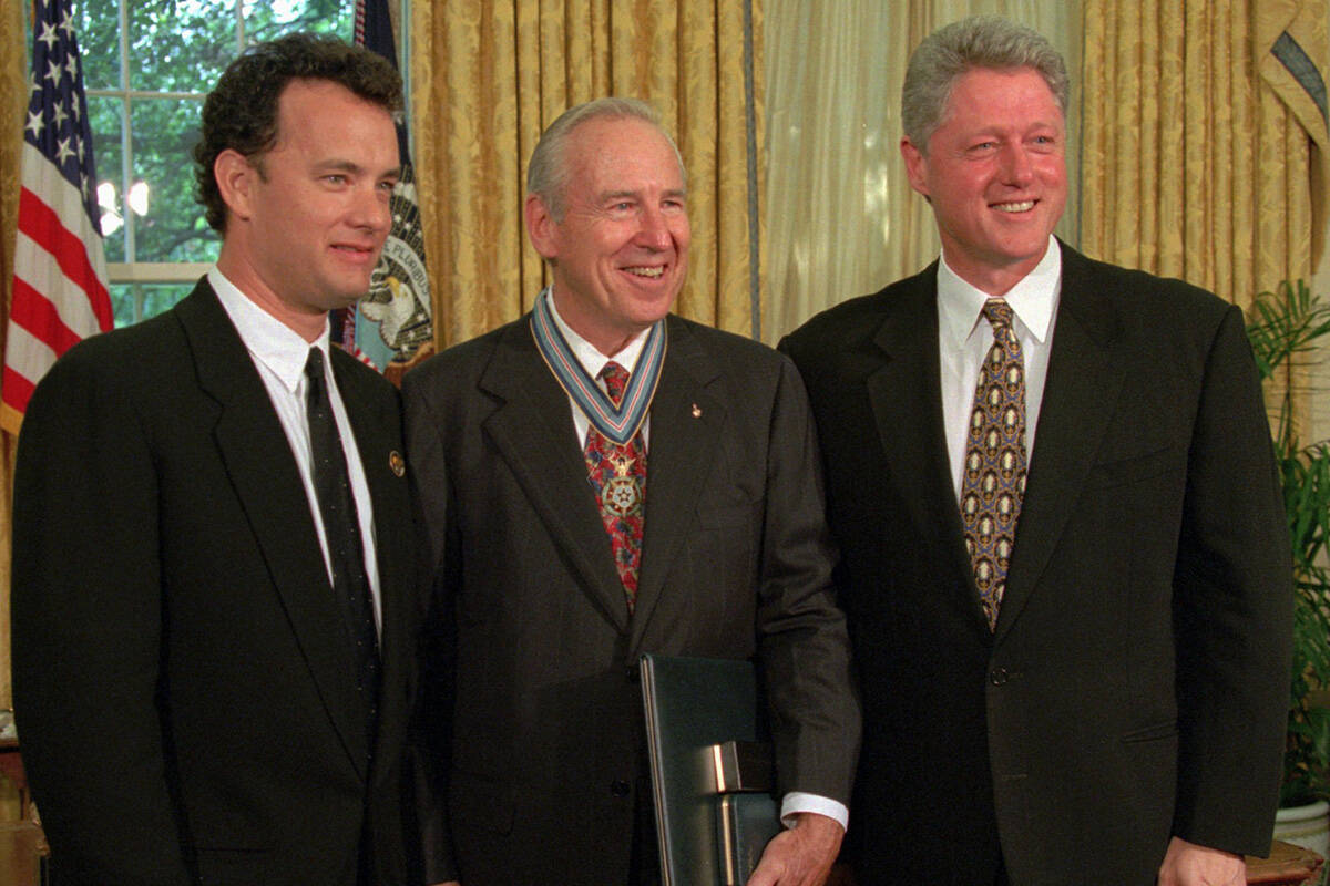 President Clinton poses with actor Tom Hanks, left, and former astronaut James Lovell in the Ov ...