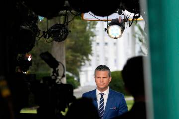 Defense Secretary Pete Hegseth prepares to give a television interview outside the White House ...
