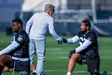Raiders head coach Pete Carroll greets defensive tackle Treven Ma'ae (68) as he stretches with ...