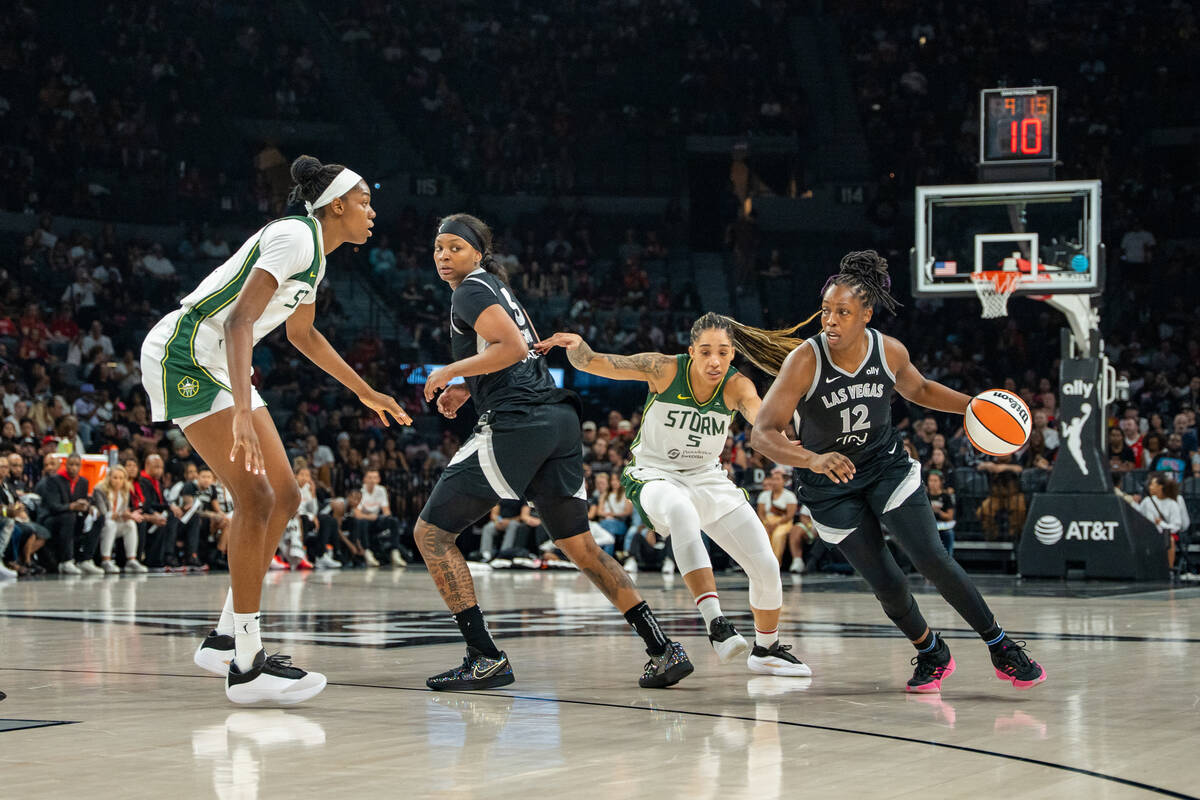 Las Vegas Aces guard Chelsea Gray (12) brings the ball up the court at a WNBA basketball game b ...