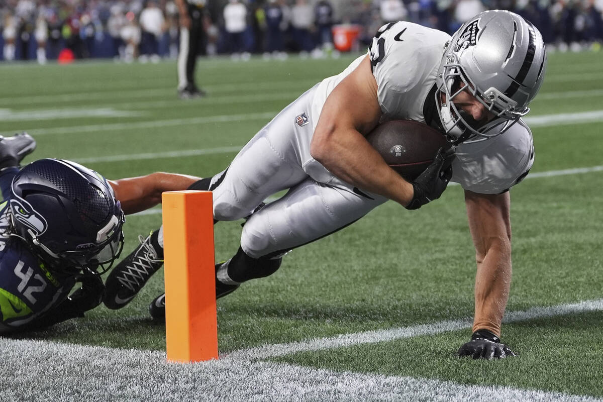 Las Vegas Raiders running back Dylan Laube (23) scores a touchdown past Seattle Seahawks lineba ...