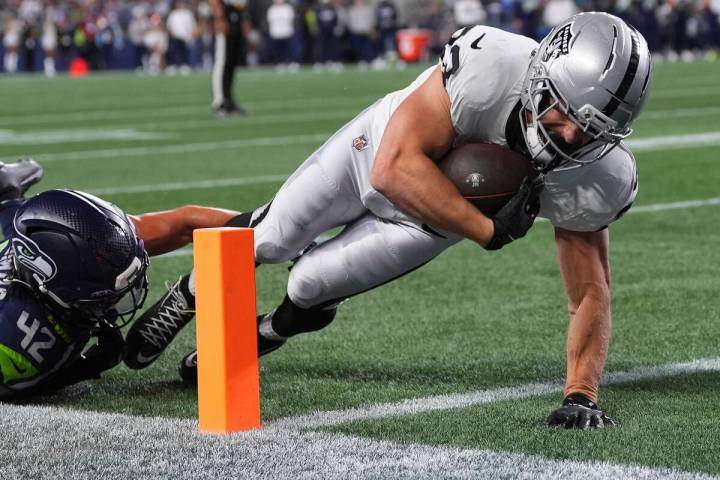 Las Vegas Raiders running back Dylan Laube (23) scores a touchdown past Seattle Seahawks lineba ...