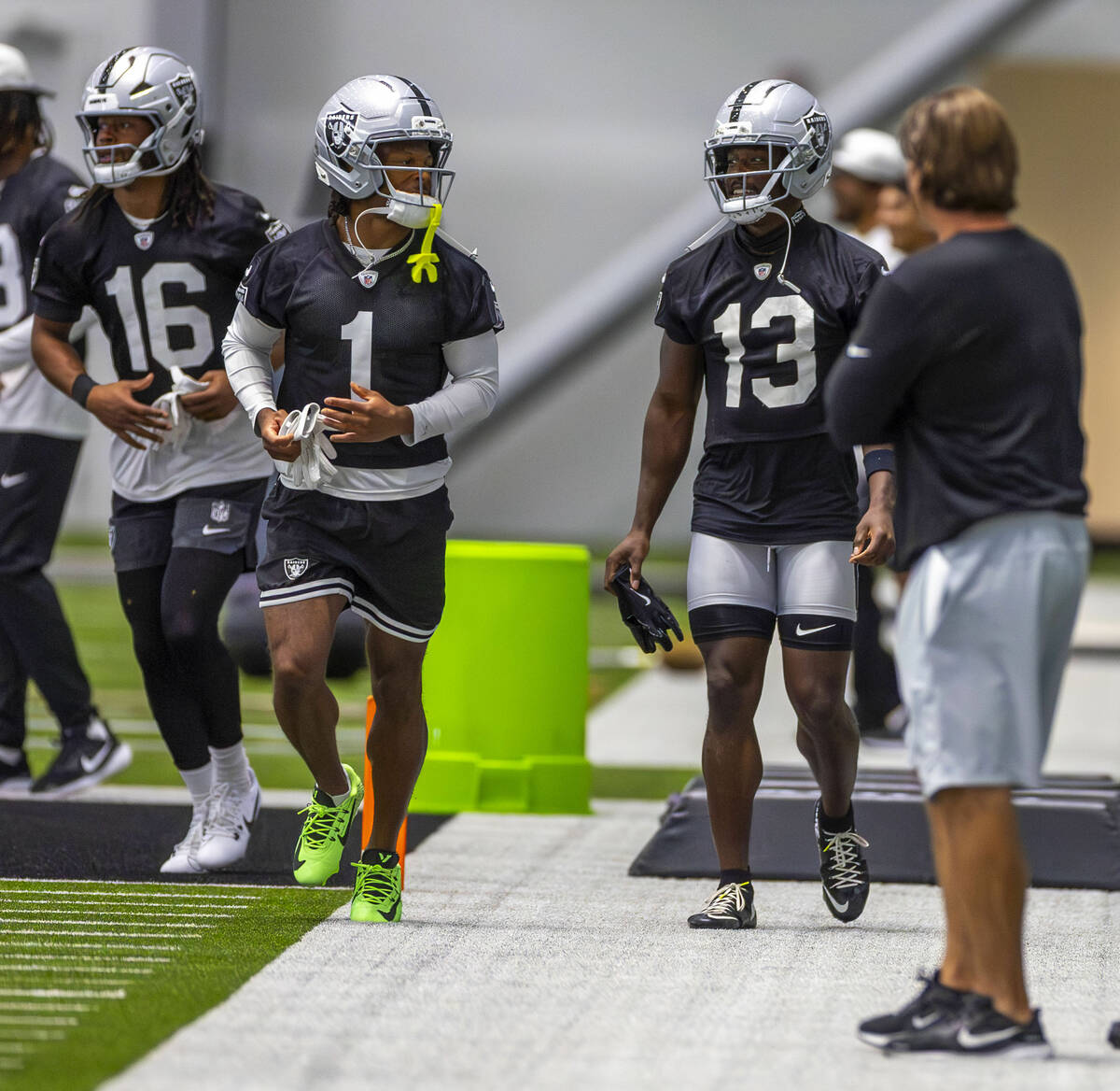 Raiders wide receivers Tre Tucker (1) and Phillip Dorsett II (13) chat while warming up during ...