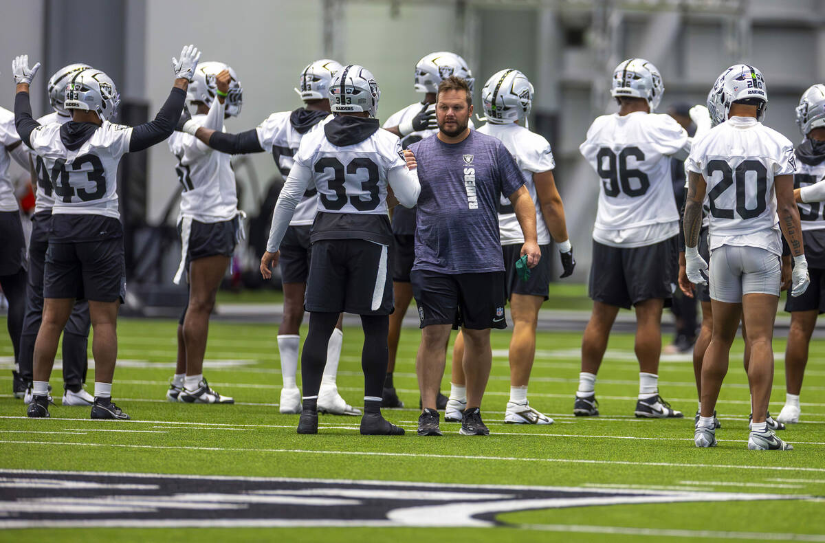 Raiders linebacker Jamal Adams (33) greets a staff member during training camp in the Intermoun ...