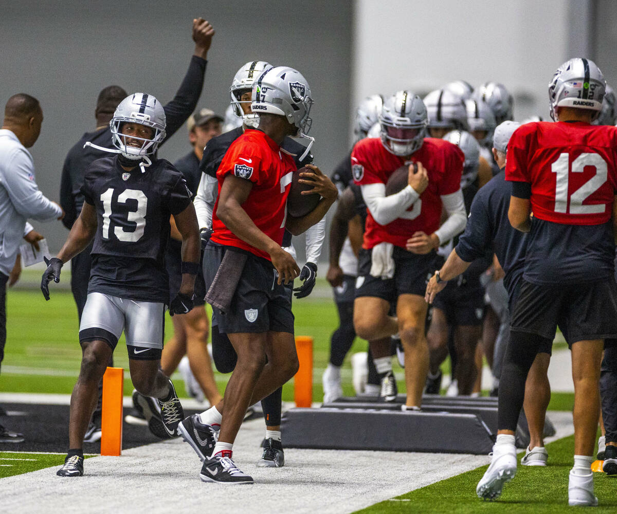 Raiders wide receiver Phillip Dorsett II (13) looks to quarterback Geno Smith (7) as they compl ...